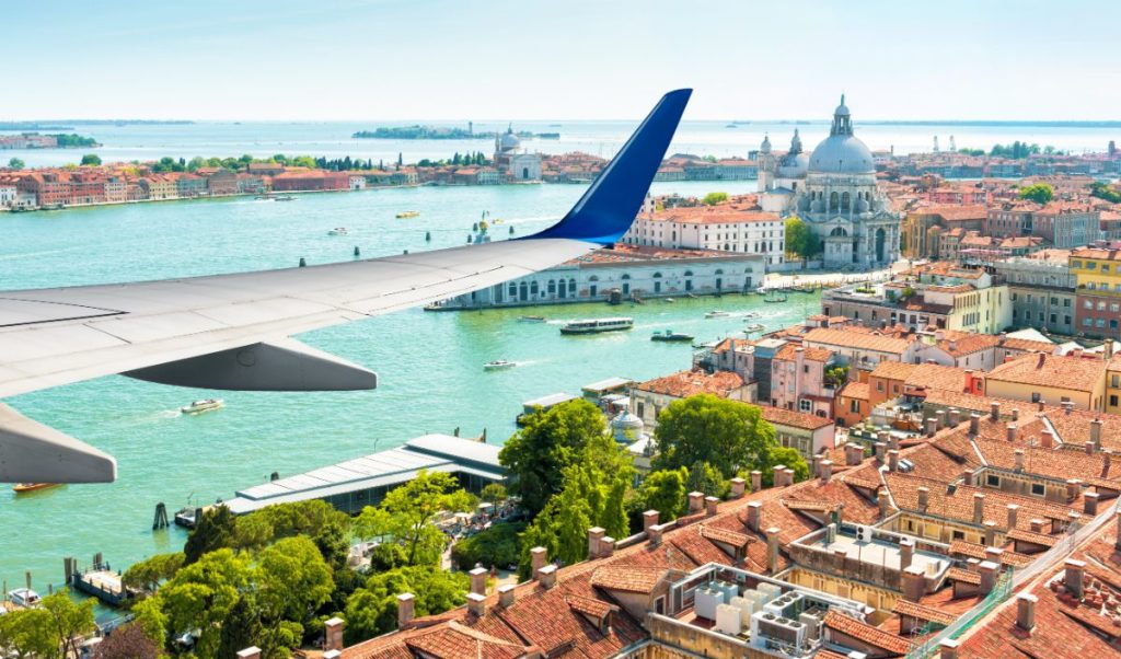 Fly over Venezia med panoramautsikt fra flyvinduet, Italia.