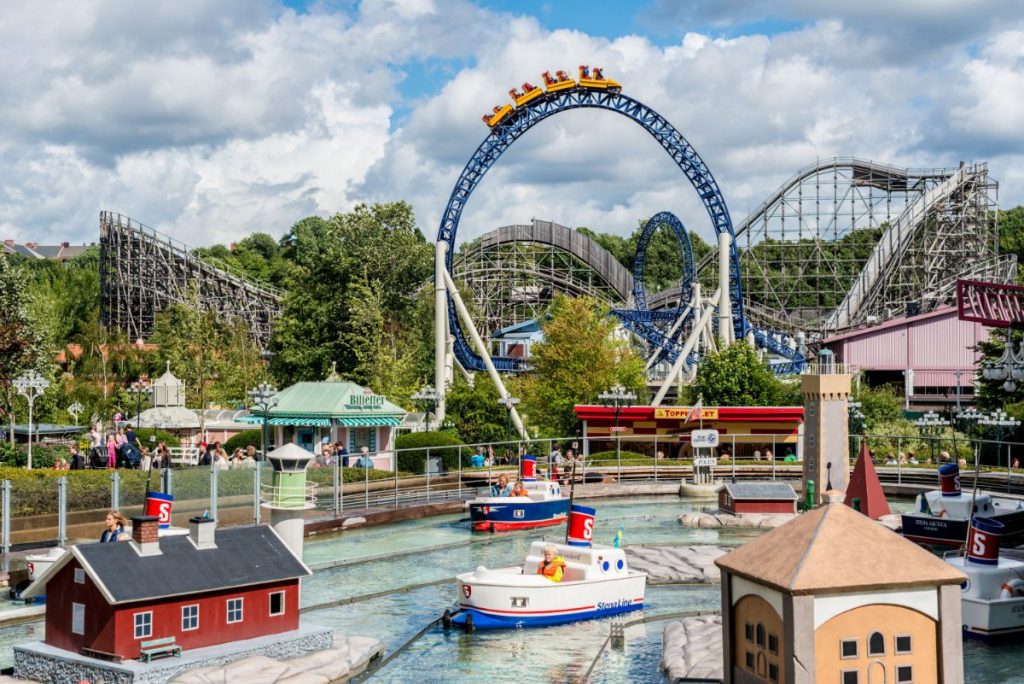 Båtkarusell og berg-og-dalbaner i livlige Liseberg fornøyelsespark, Göteborg.
